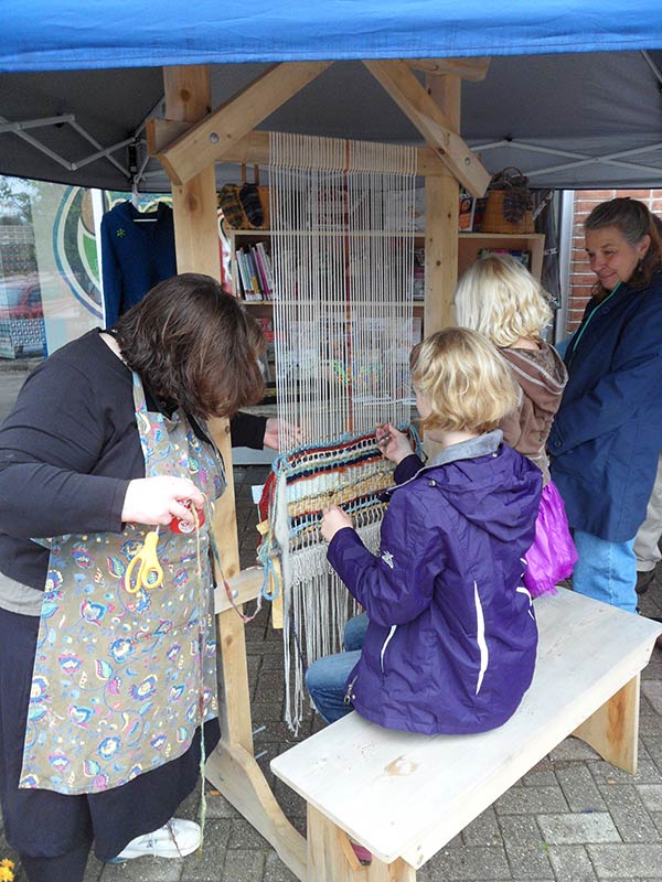 Weaving under the tent at the Library