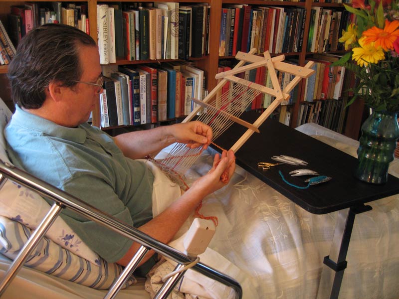 Man weaving on the Journey Earthloom in hospital bed