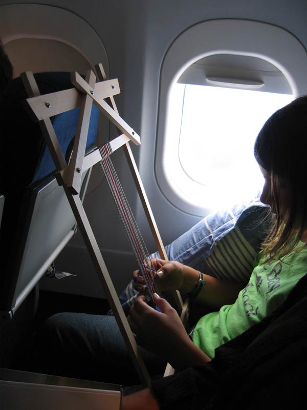 Girl weaving on Journey Loom in flight