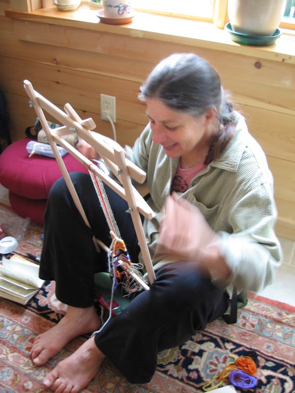 A participant in action weaving an amulet
